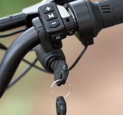 Ignition Key for GT73 e-bike inserted in handlebar ignition switch for secure power control.
