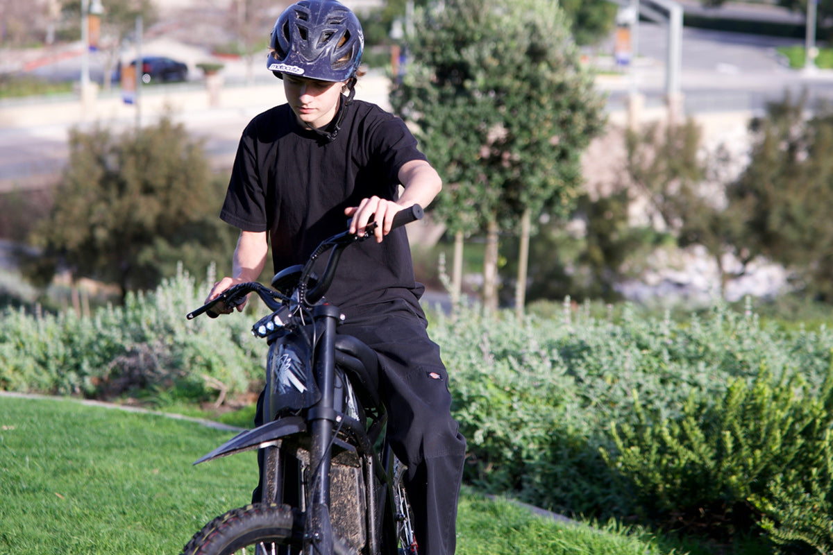 GT73 Electric Motorbike with rider outdoors, featuring off-road tires.