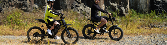A man and a woman riding Riding'times electric bikes in the mountain