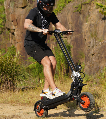 G63 Dual Motor Electric Scooter off-road with rider, showcasing robust suspension and tubeless tires.