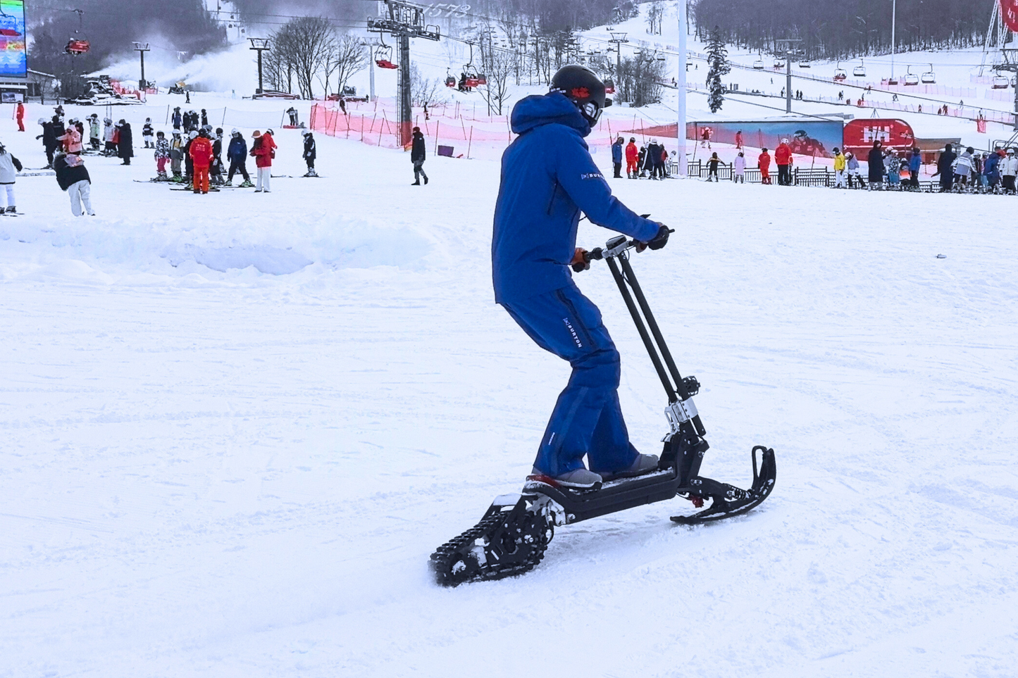 G63 Convertible Electric Scooter with ski kit on snow terrain.